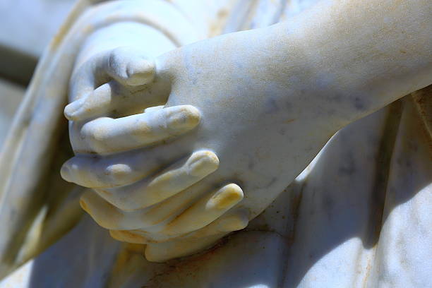 Detail of marble Virgin Mary praying hands Detail of marble Virgin Mary praying hands statue in a public cemetery of Southern Brazil. sistine madonna stock pictures, royalty-free photos & images