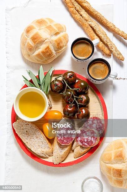 Italian Snack Lunch Black Sicilian Tomatoes Salami Bread In T Stock Photo - Download Image Now