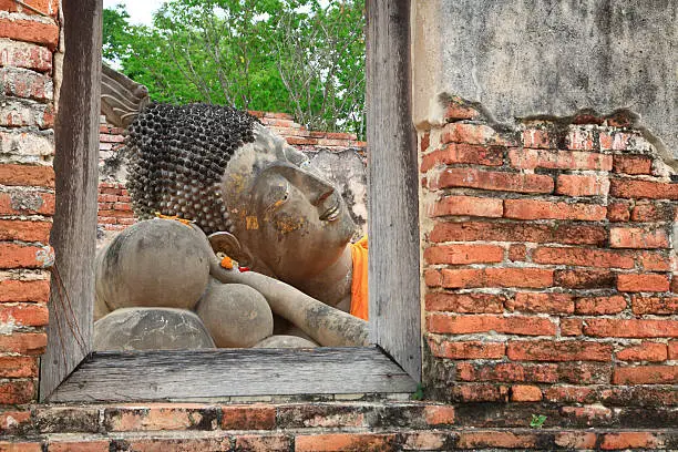 Reclining Buddha  from window frame at  Historical Park Ayutthaya, Thailand