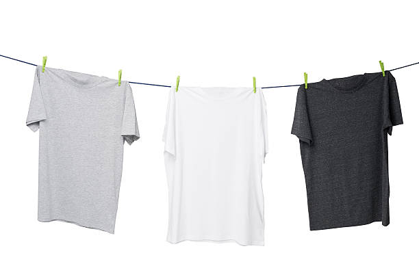 istock three t-shirts on the rope (grey, white and dark grey). 480504442