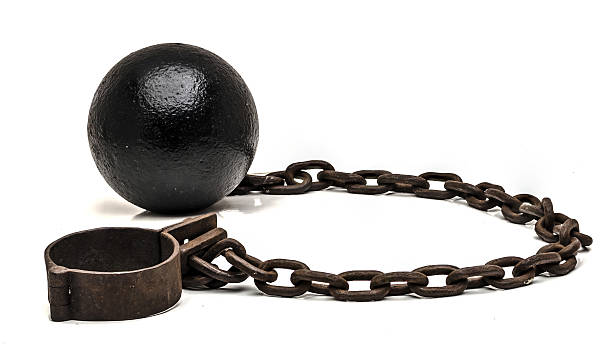 Ball and chain on white background Ball and chain on white backgroundBall and chain on white background bounty hunter stock pictures, royalty-free photos & images