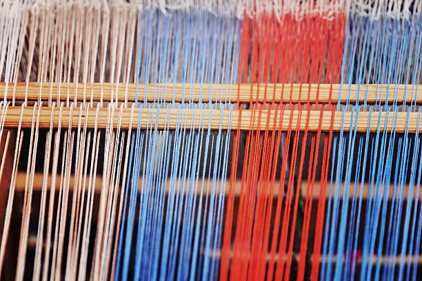 istock Multicolored thread on a weaving loom taken closeup. 480510362