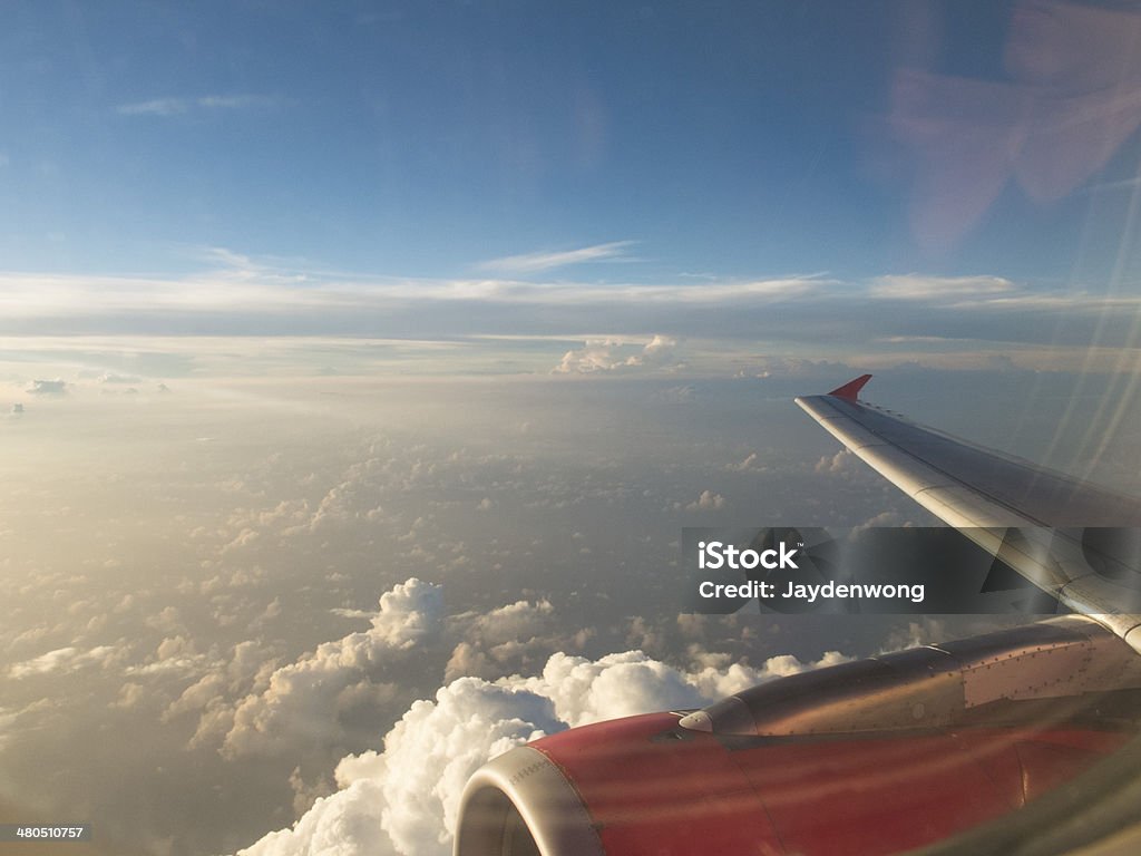 Wing of Aircraft over the Sky Wing of aircraft under sunset light. Aircraft Wing Stock Photo