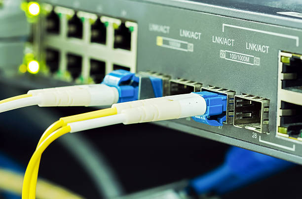 Optical single mode LC patch cord Optical fiber cable single mode LC patch cord with blue connector plug in to equipment broadband isp stock pictures, royalty-free photos & images