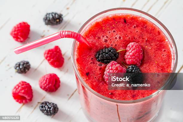 Banana Raspberry And Blackberry Smoothie White Wood Background Stock Photo - Download Image Now