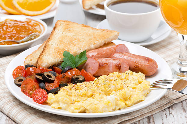 istock scramble eggs with tomatoes, sausage and toast for breakfast 480517549