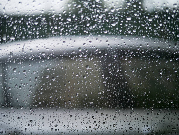 istock Road view through car window with rain drops 480518622