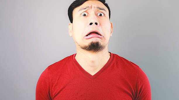 istock Asian man in red T-shirt is feeling badly shocked. 480519284