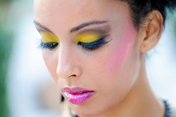 Portrait of young female face with eyes closed. Woman with lilac beauty eyes makeup. Girl with perfect skin and purple smoky eyes eye shadows.