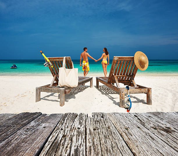istock Couple in yellow relax on a beach at Maldives 480520540