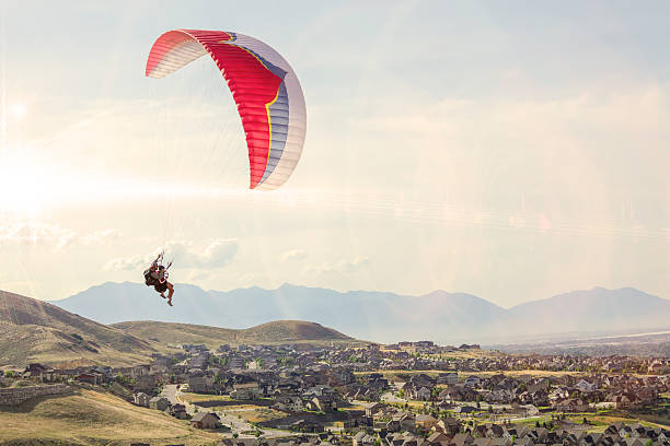 Tandem Paraglide Couple Tandem Paraglide paraglider stock pictures, royalty-free photos & images