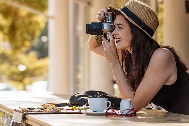 istock young beautiful traveler happily taking photos with camera at ca 480530914