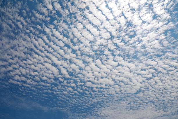 Cirrocumulus Cloud Cirrocumulus Cloud in blue sky on sunny peaceful day. cirrocumulus stock pictures, royalty-free photos & images