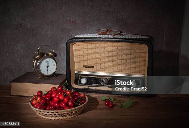 The Old Radio And Fresh Cherries Stock Photo - Download Image Now - Alarm Clock, Antique, Berry Fruit