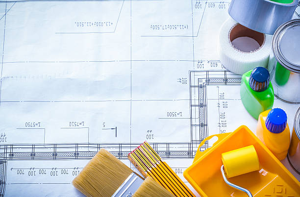 istock Duct tape wooden meter and paint tools on construction drawing 480534328