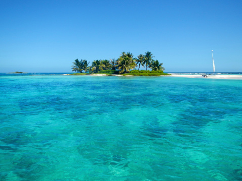 Beautiful turquoise colored water near an idyllic island, barrier reef in Belize, Central America, Caribbean.