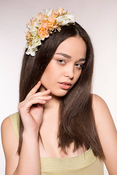 istock beautiful brunette with flower's headband 480536993