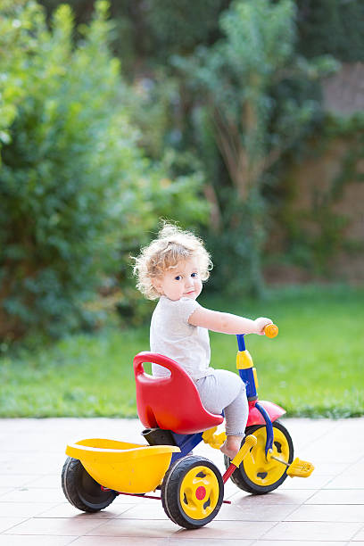 istock Cute happy smiling baby girl riding her first bicycle 480537007