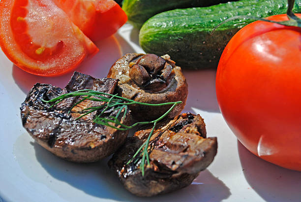 istock Tomato, cucumber, mushrooms baked, dill on a white plate 480542152