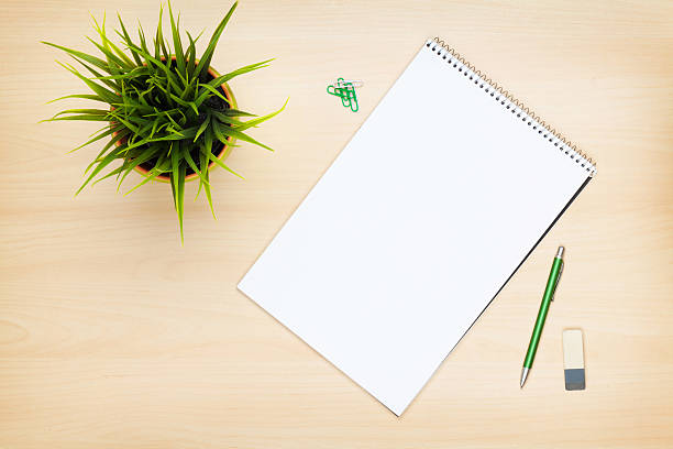 istock Blank notepad, pen and flower on wooden table 480543786