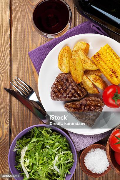 Steak With Grilled Potato Corn Salad And Red Wine Stock Photo - Download Image Now