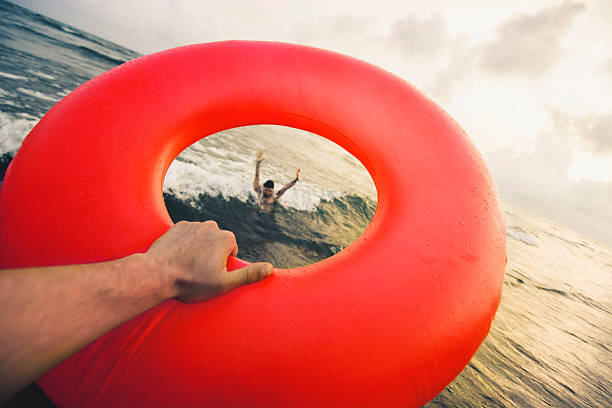 Lifeguard trying to help with life belt