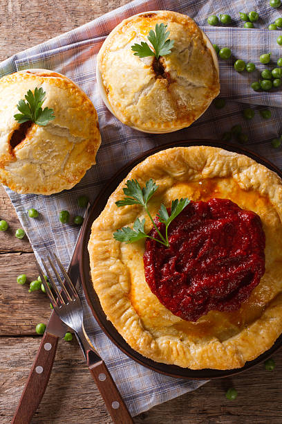 istock Australian meat pie on the table, vertical view from above 480549580