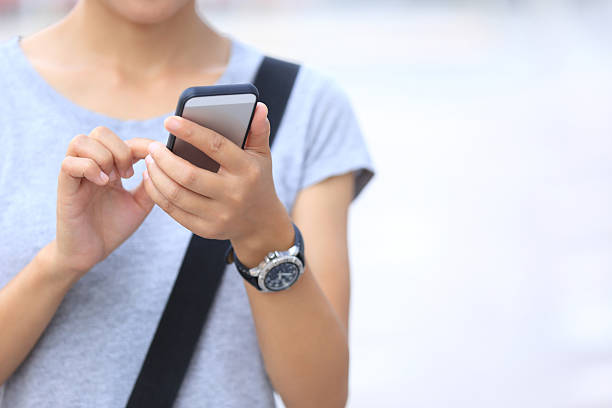 istock young asian woman use smartphone at city 480553438