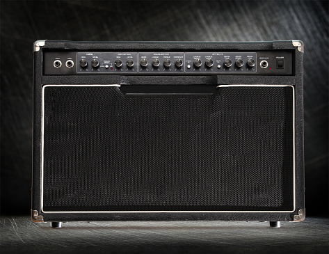 Guitar amplifier on black steel scratchy background