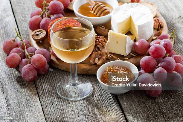 Glass Of Cold White Wine And Snacks On Wooden Table Stock Photo - Download Image Now