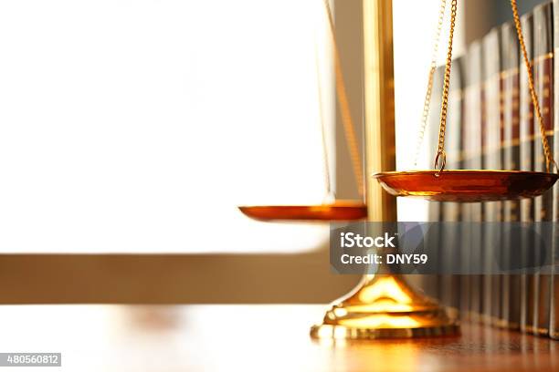 Justice Scale Next To Row Of Law Books Stock Photo - Download Image Now - Equal-Arm Balance, Lady Justice, Law