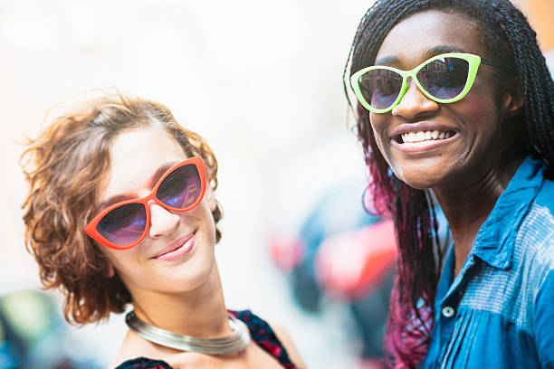 istock Two smiling mixed race girlfriends on the street 480561096