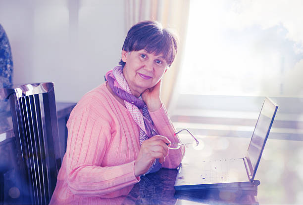istock Pension age woman working on laptop 480561422