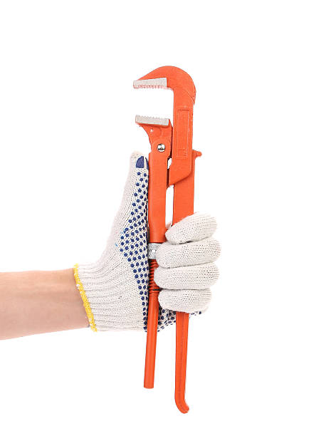istock Wrench in white and yellow glove. 480561813
