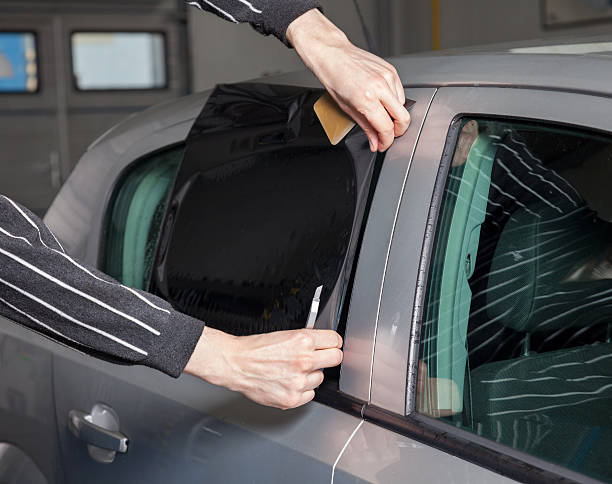 istock Applying tinting foil on a car window 480562124