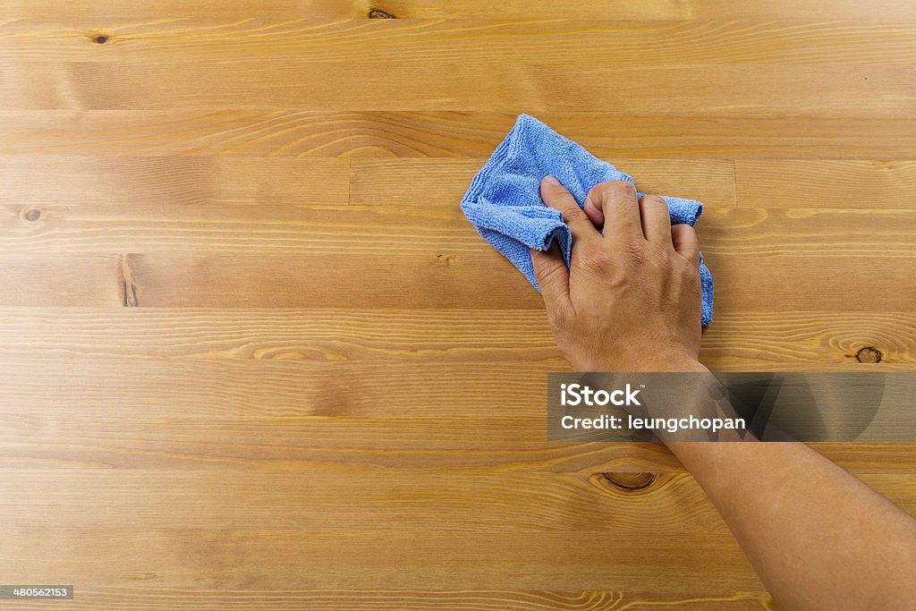 Cleaning table by hand Adult Stock Photo