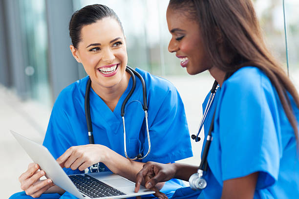 istock young female nurses having fun with laptop 480569871