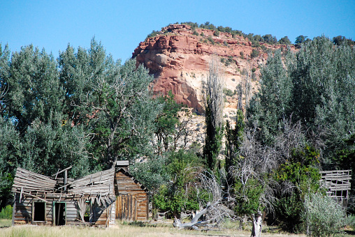 Decaying, abandoned, derelict and decrepit Old Gunsmoke movie set in Johnson Canyon near Kanab Utah now rotting in cattle pastures on a ranch