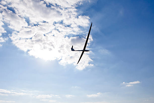 Glider keeping water on the background of the setting sun stock photo