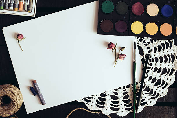 istock Blank paper mockup with artist brushes on wooden table 480572828