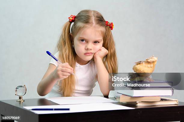 Child At The Lessons At The Table Stock Photo - Download Image Now - Book, Child, Concentration