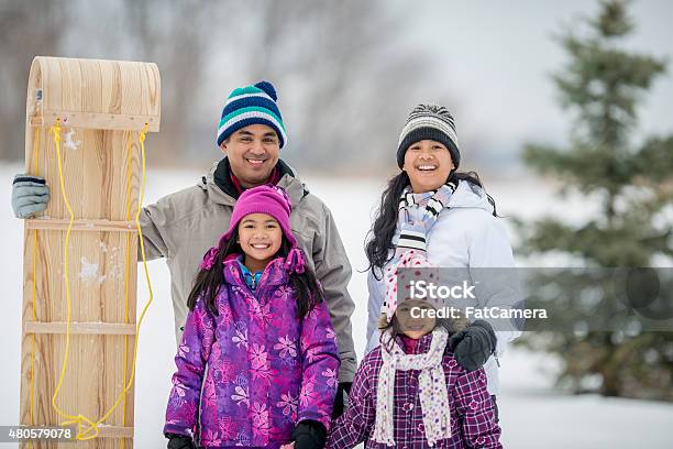 Family Tobogganing Stock Photo - Download Image Now - 2015, Activity, Adult