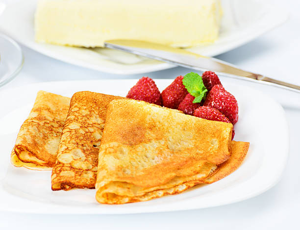istock Russian pancakes with black tea and strawberries. 480579093