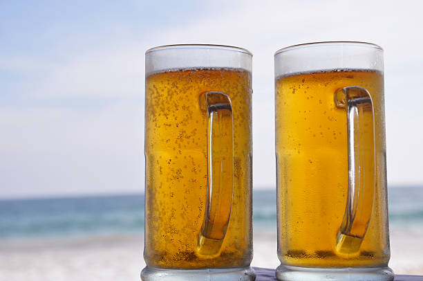 Beer In A Cold Glass On A Timber Bar Counter With A Summer FeelAnd Fruit In The Background