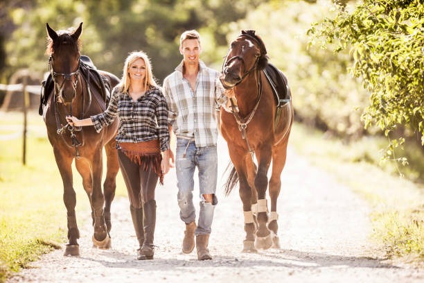 istock Couple walking their horses. 480585449