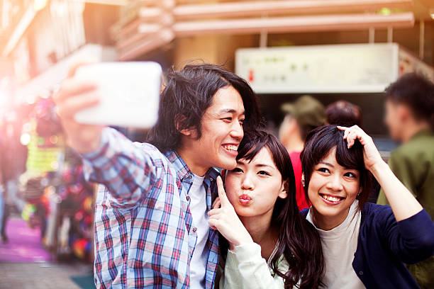 istock Group of young japanese people making selfie, Tokyo, 480585472