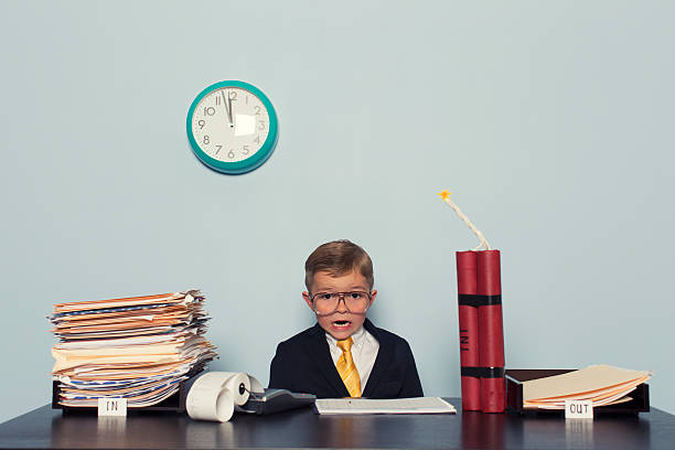 istock Young Boy at Business Desk Awaits Deadline 480585551