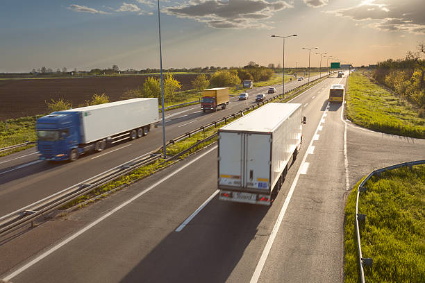 istock Two trucks on the highway at sunset in motion blur 480586156
