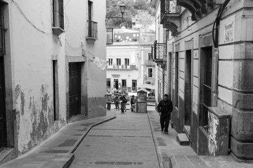 Guanajuato, Mexico- June 21, 2012: People walking down a typical alley in the residential area of Guanajuato downtown, a UNESCO world heritage site