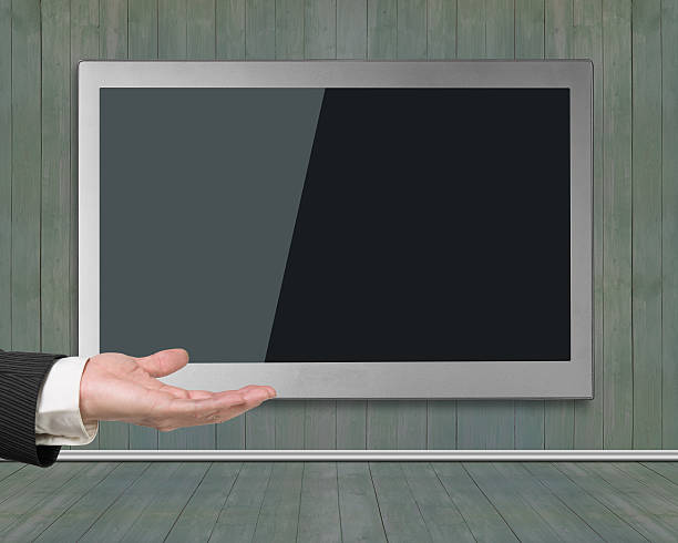 istock Blank black wide flat TV screen hanging on wooden wall 480593848